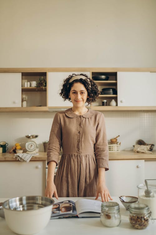 Curly Haired Woman Holding A Cookbook