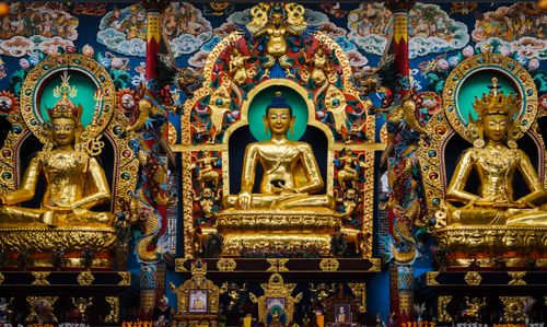 Free Intricately adorned Buddhist statues in Namdroling Monastery, India, showcasing detailed religious art. Stock Photo