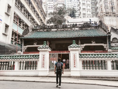 Free 
A Man Carrying a Backpack Looking at the Man Mo Temple in Hong Kong Stock Photo