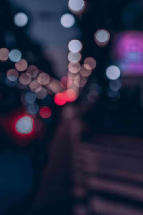 Free Blurred city street lights at night creating a beautiful bokeh effect, perfect for artistic and abstract projects. Stock Photo