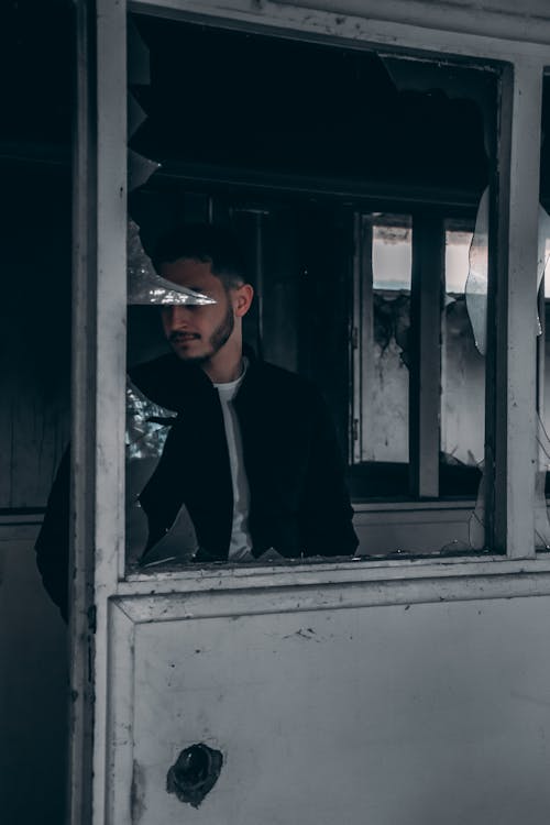 Free 
A Bearded Man Wearing a Jacket in an Abandoned Building Stock Photo