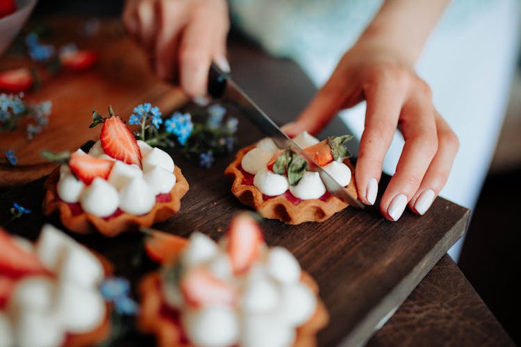 Crop Woman Cutting Cake With Berries