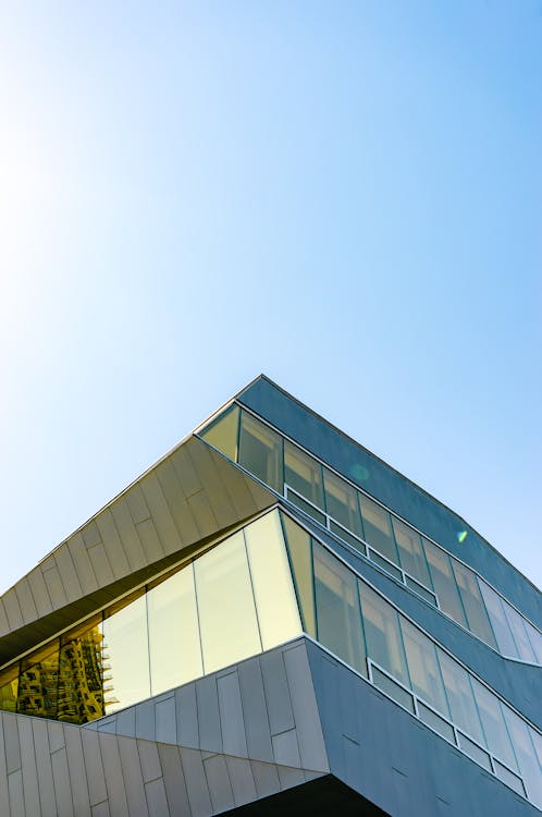 Low Angle Shot of Glass Building Under Blue Sky