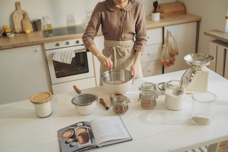 Woman Mixing Baking Ingredients In A Bowl