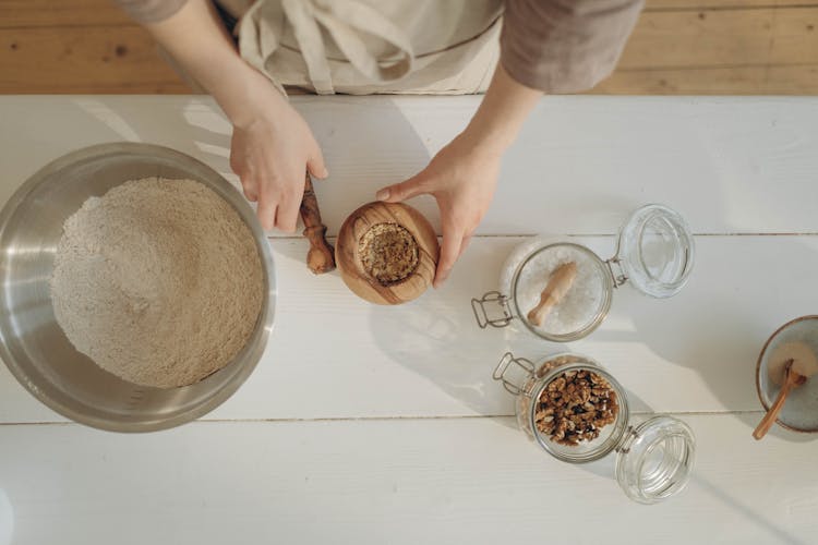 A Baker Holding A Mortar And Pestle