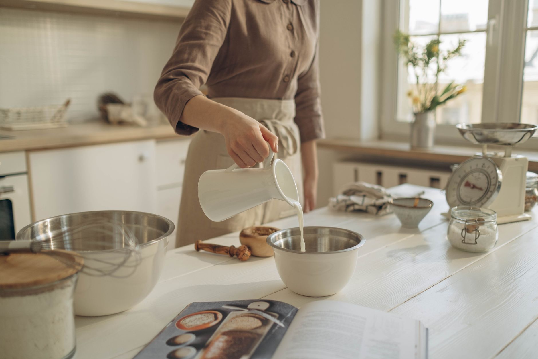 Pouring creamy sauce into a pan