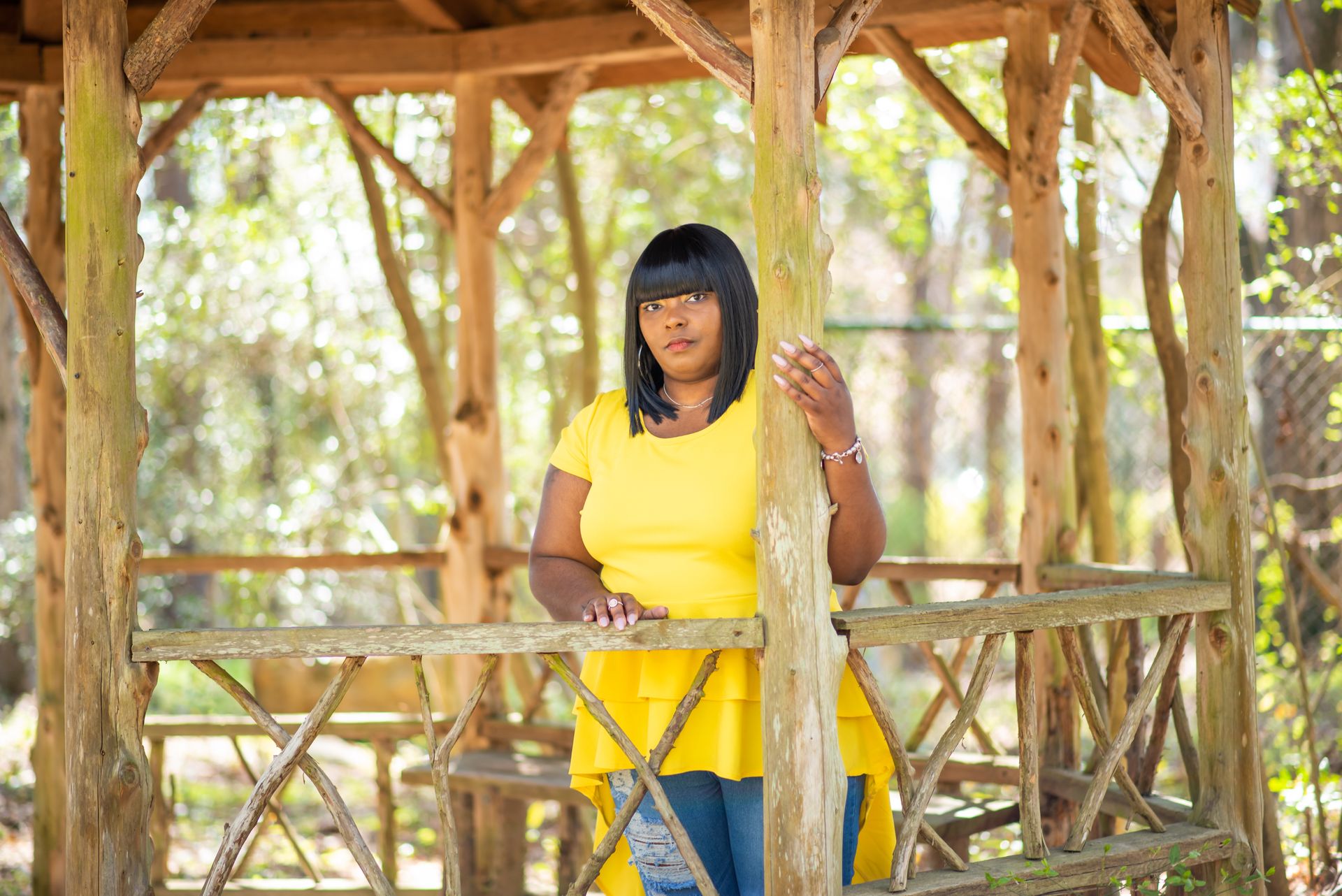 A Woman in Yellow Shirt Standing Inside the Wooden Gazebo