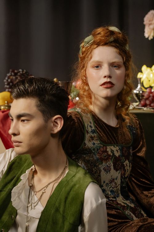 Free Elegant renaissance-style portrait of a young couple indoors. Stock Photo