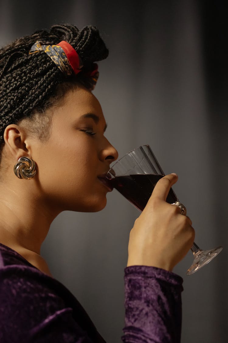 Close-Up Shot Of A Woman Drinking A Glass Of Wine