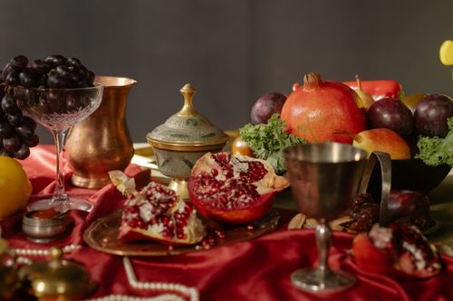 Free Elegant baroque style still life featuring fruits and vintage goblets on a red cloth. Stock Photo