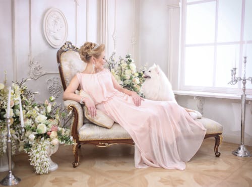 Woman in Link Pink Dress Lying Down on the Sofa