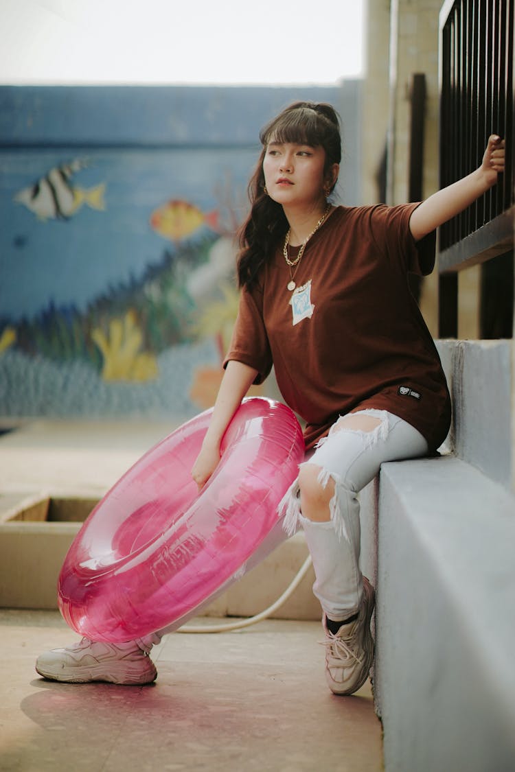 Woman Holding A Pink Inflatable Floating Ring 