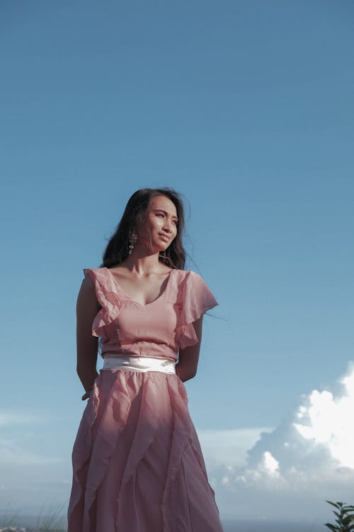 Free Woman in Pink Dress Under Blue Sky Stock Photo