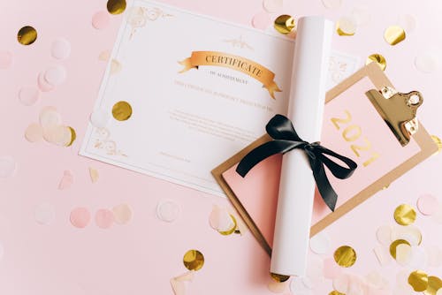 Certificate of Achievement and Diploma among Confetti