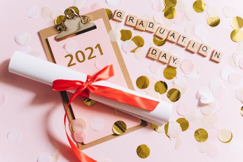 Paper Scroll with Red Ribbon Lying on a Clipboard