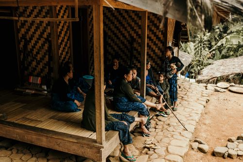Free A family gathering outside a wooden house in rural Banten, Indonesia, highlighting traditional lifestyle. Stock Photo
