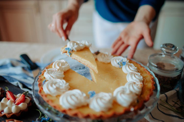 Anonymous Woman With Pie On Tray On Table In Kitchen