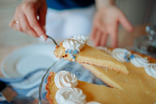 A Person Holding a Slice of Cake