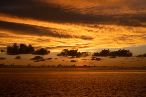 Free Vibrant sunset over the ocean in Kota Kinabalu, with golden clouds and serene waters. Stock Photo