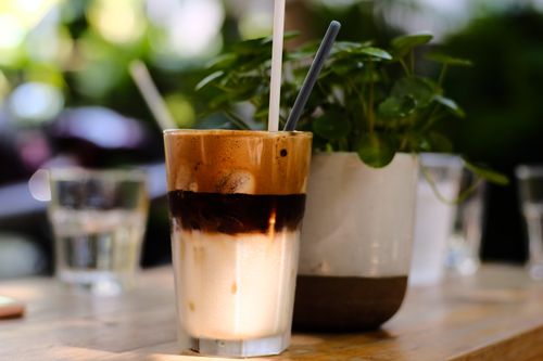 Free Close-up of a delicious iced coffee with straws, perfect for a sunny outdoor setting. Stock Photo
