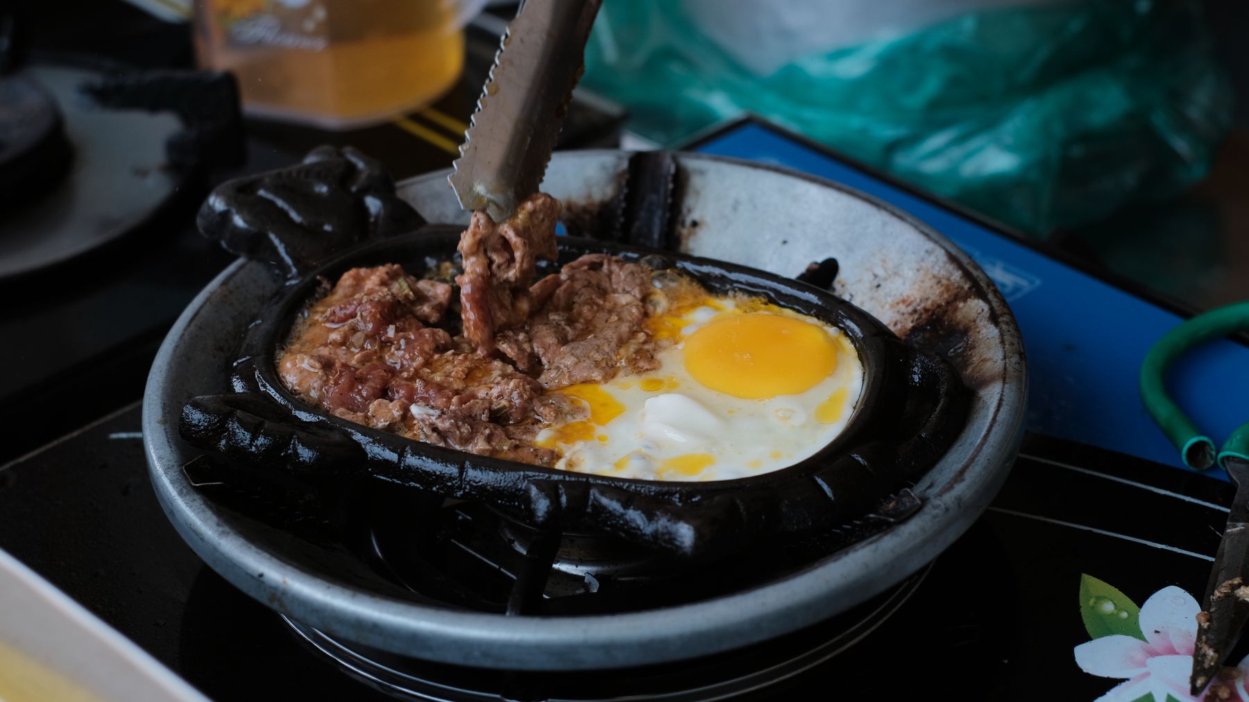 Close-up image of beef and egg being cooked in a pan, showcasing a delicious culinary moment.