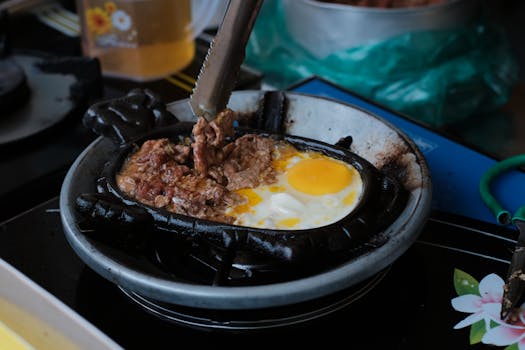 Close-up image of beef and egg being cooked in a pan, showcasing a delicious culinary moment.