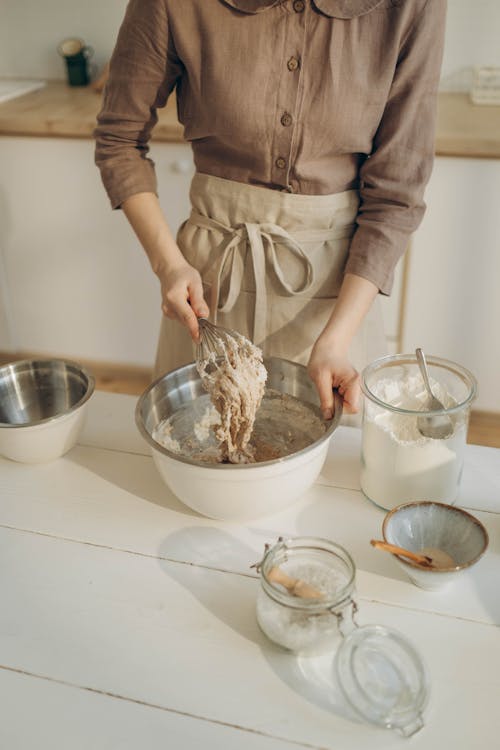 Free Person Holding a Bowl and a Whisk Stock Photo