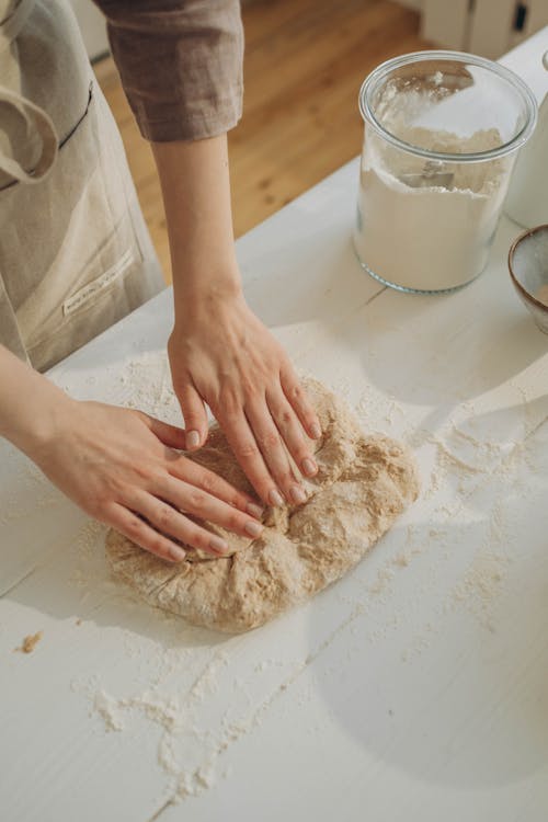 Free A Person Kneading a Dough on the White Surface Stock Photo
