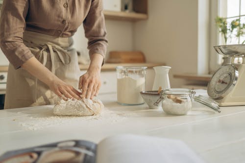 Free Person in Brown Long Sleeve Shirt Holding a Dough Stock Photo
