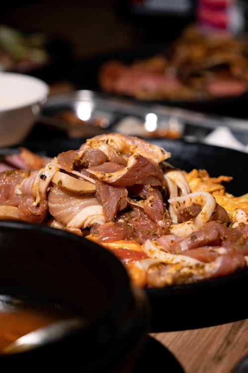 Sliced Raw Meat and Squid in the Black Plate