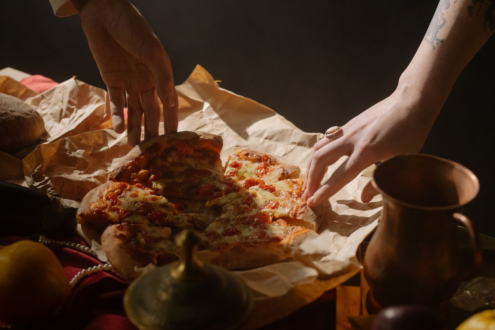 Person Holding Sliced Pizza on a Wax Paper
