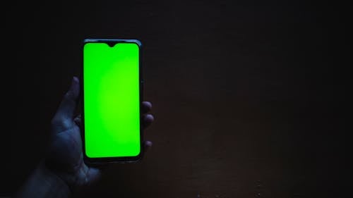 A Person Holding a Cellphone with Green Screen