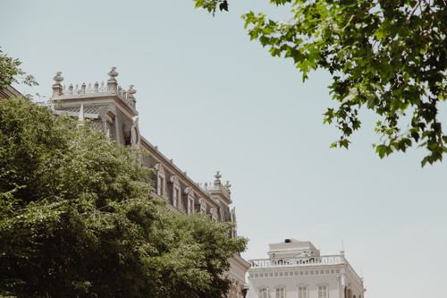 Free Majestic classic building with ornate architecture and surrounding greenery. Stock Photo