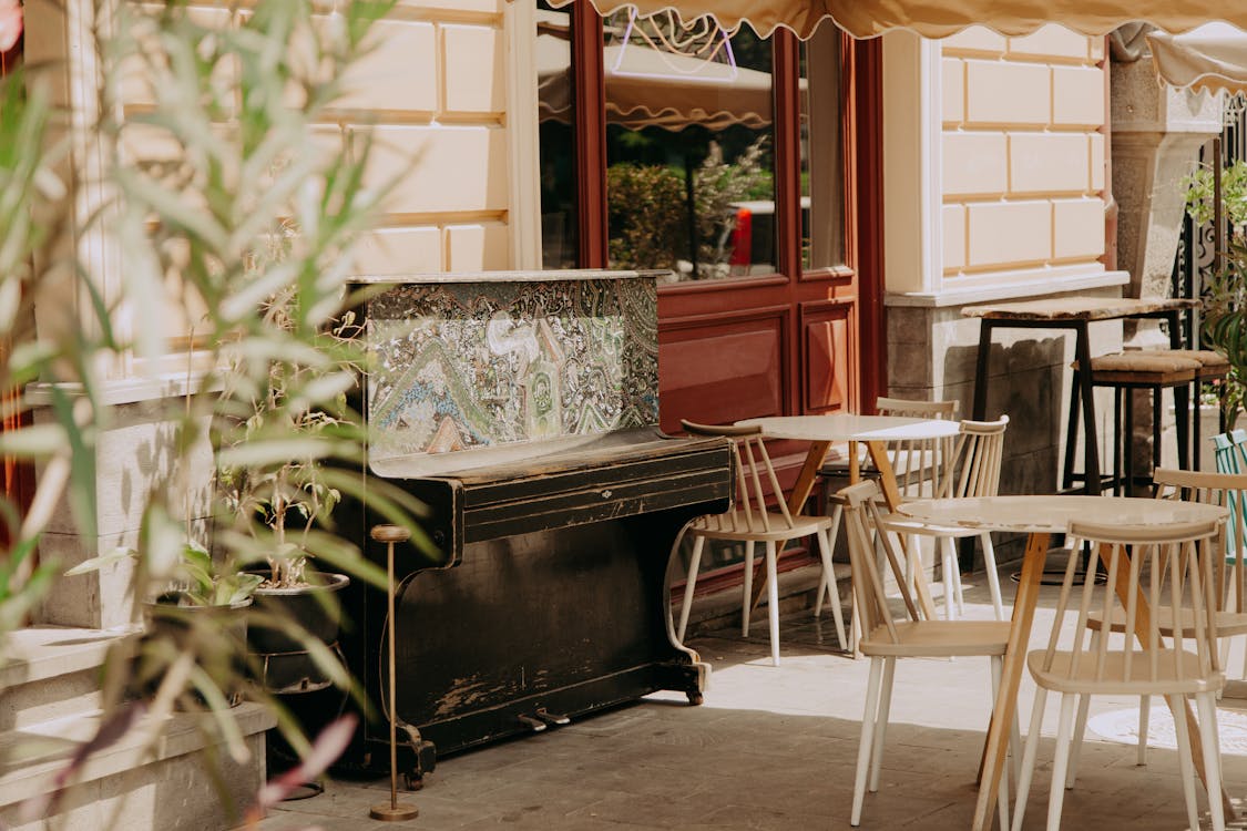 Free Wooden Table and Chairs Near the Piano Stock Photo