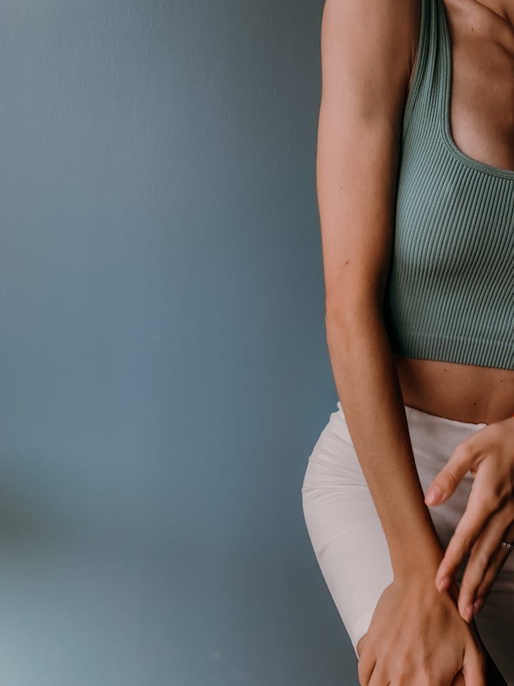 Person In Green Tank Top And Beige Pants