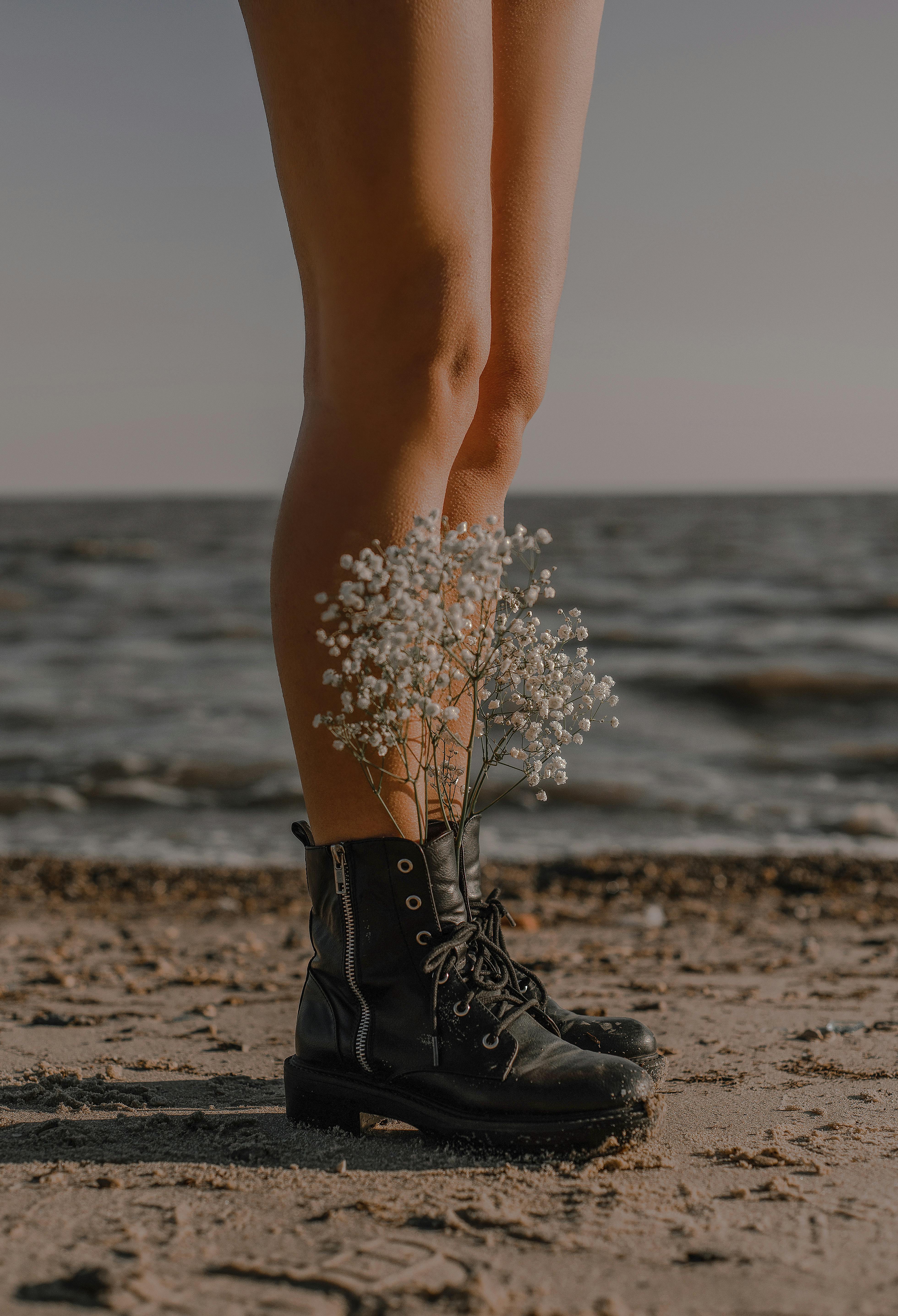 photo of wildflowers in a person s shoes