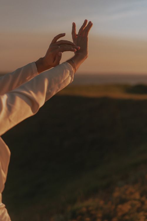 Free Hands reaching towards the sky during a peaceful sunset in a natural setting, embracing tranquility. Stock Photo