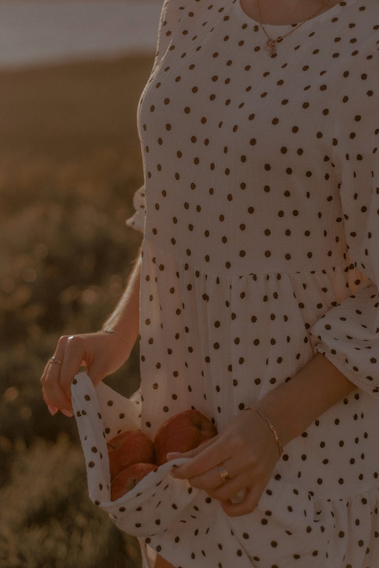 Female Hands Holding Fruit In Clothes