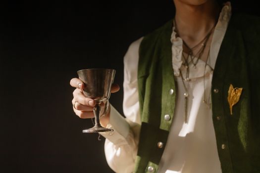 Person Holding a Silver Cup