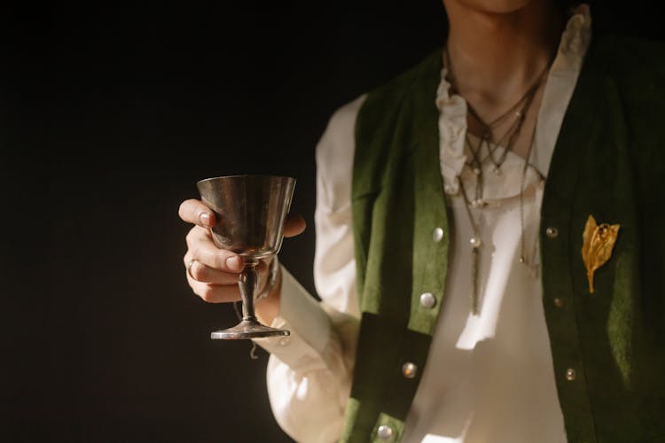 Person Holding A Silver Cup