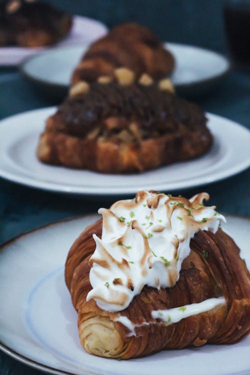 Free Croissants with Cream Topping on White Plate Stock Photo