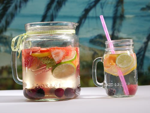 Three Clear Glass Jars With Straws