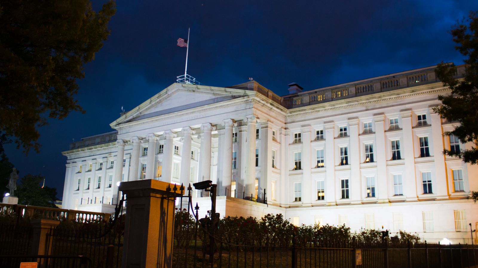 Stunning view of the U.S. Treasury Building illuminated against a twilight sky in Washington, DC.
