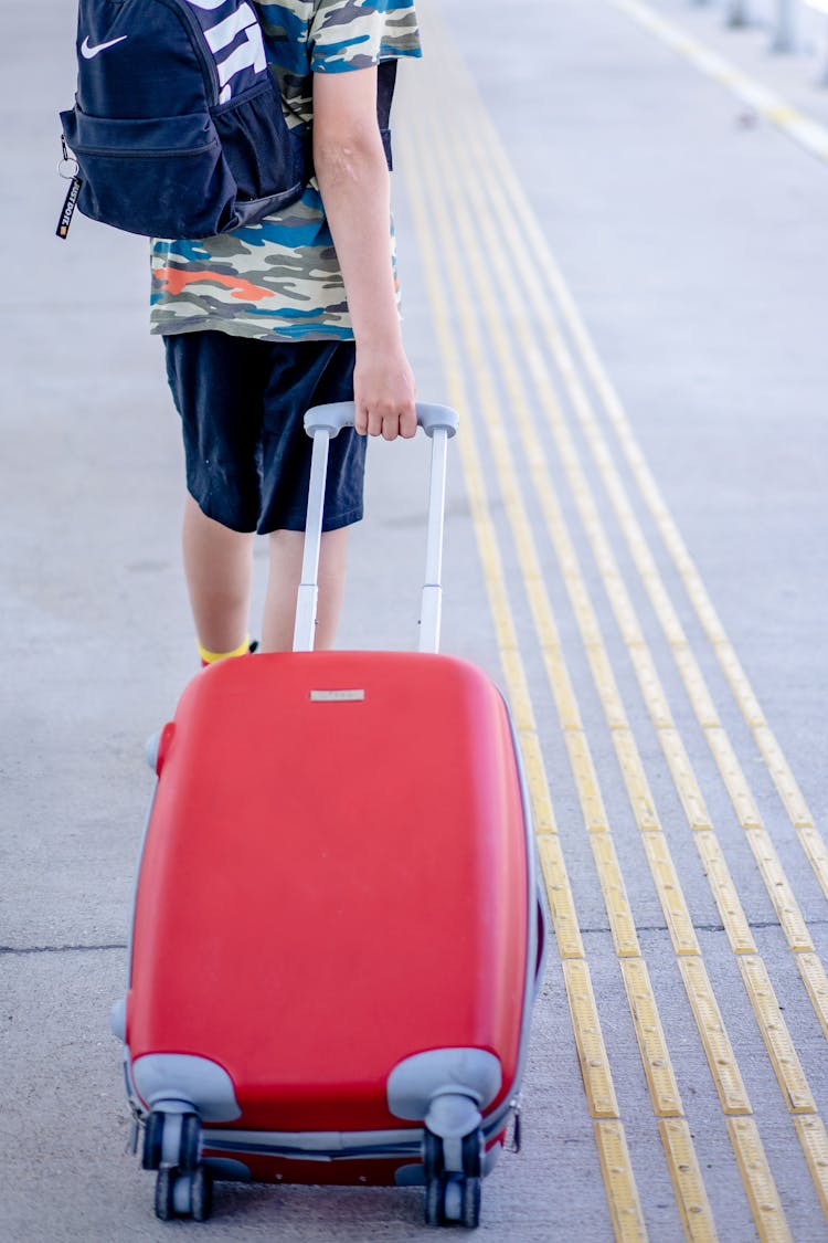 Person Walking With A Trolley Luggage Bag