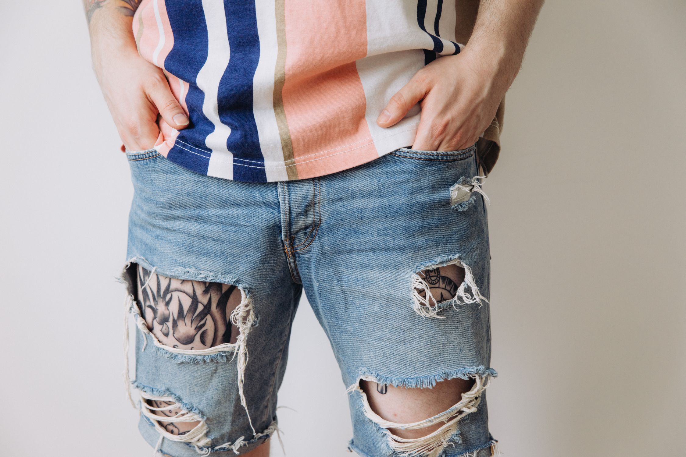 Person Ripped Clothes Person in Striped Shirt and Ripped Denim Jeans · Free Stock Photo