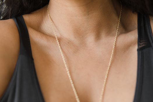 Close Up Photo of a Person Wearing Necklace