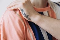 Person With Dagger Tattoo on Left Hand