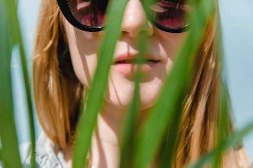 Close-up of a Woman in Front of Plants