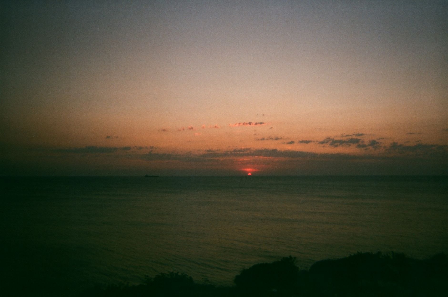 Serene sunset over Bozcaada, Turkey, with a peaceful ocean view and vivid skies.
