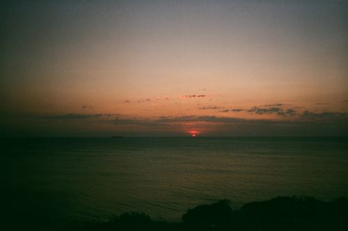 Free Serene sunset over Bozcaada, Turkey, with a peaceful ocean view and vivid skies. Stock Photo